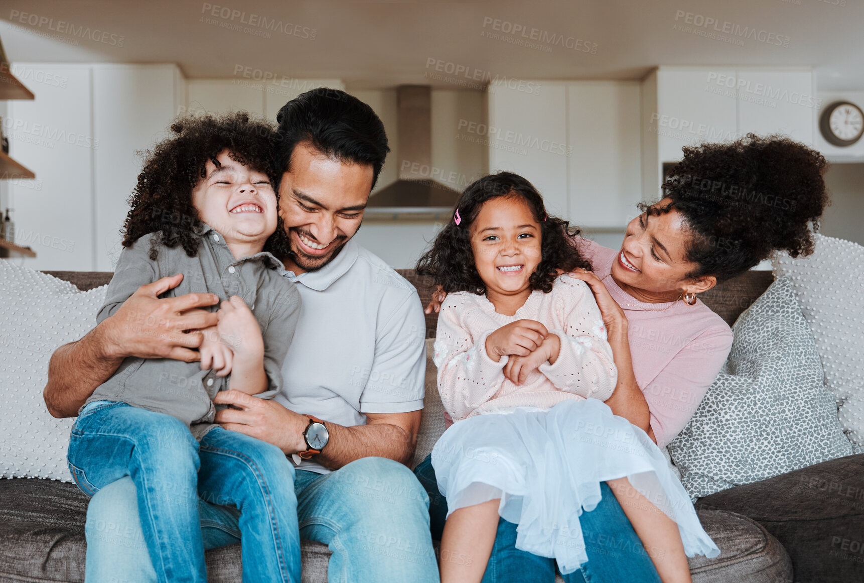 Buy stock photo Mother, father and kids on sofa, playing and happy family bonding together in living room. Smile, happiness and parents relax with kids on couch, spending playful and quality time in home on weekend.