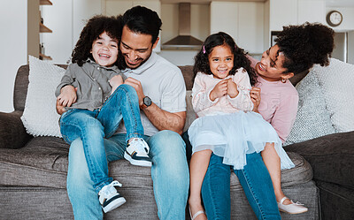 Buy stock photo Mother, father and kids on sofa, playing and happy family bonding together in living room. Smile, happiness and parents relax with young children on couch, playful and spending quality time in Mexico