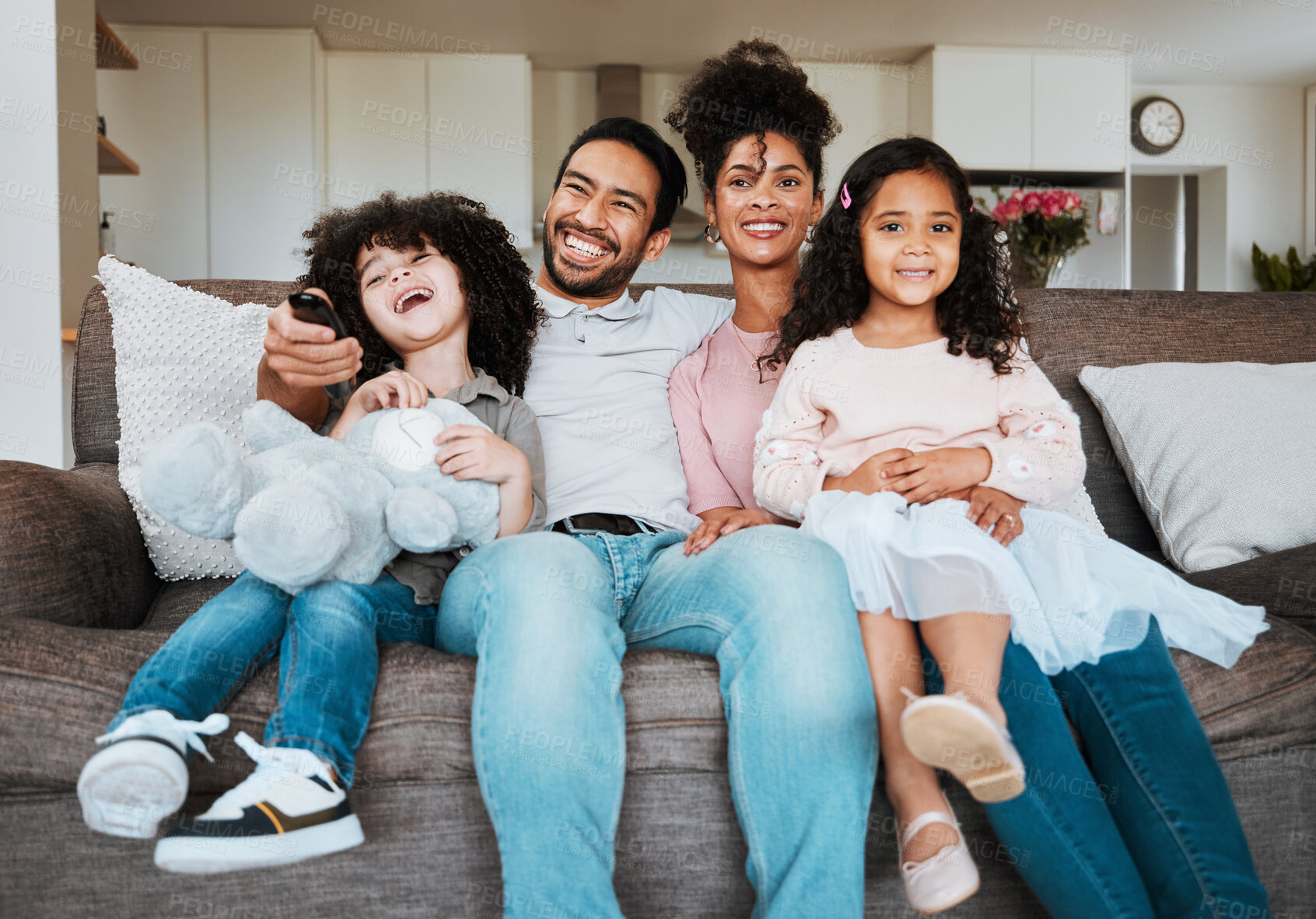 Buy stock photo Mom, dad and children on sofa, watching tv and happy family bonding together in living room. Smile, happiness and parents relax with kids on couch, streaming television show subscription or movies.