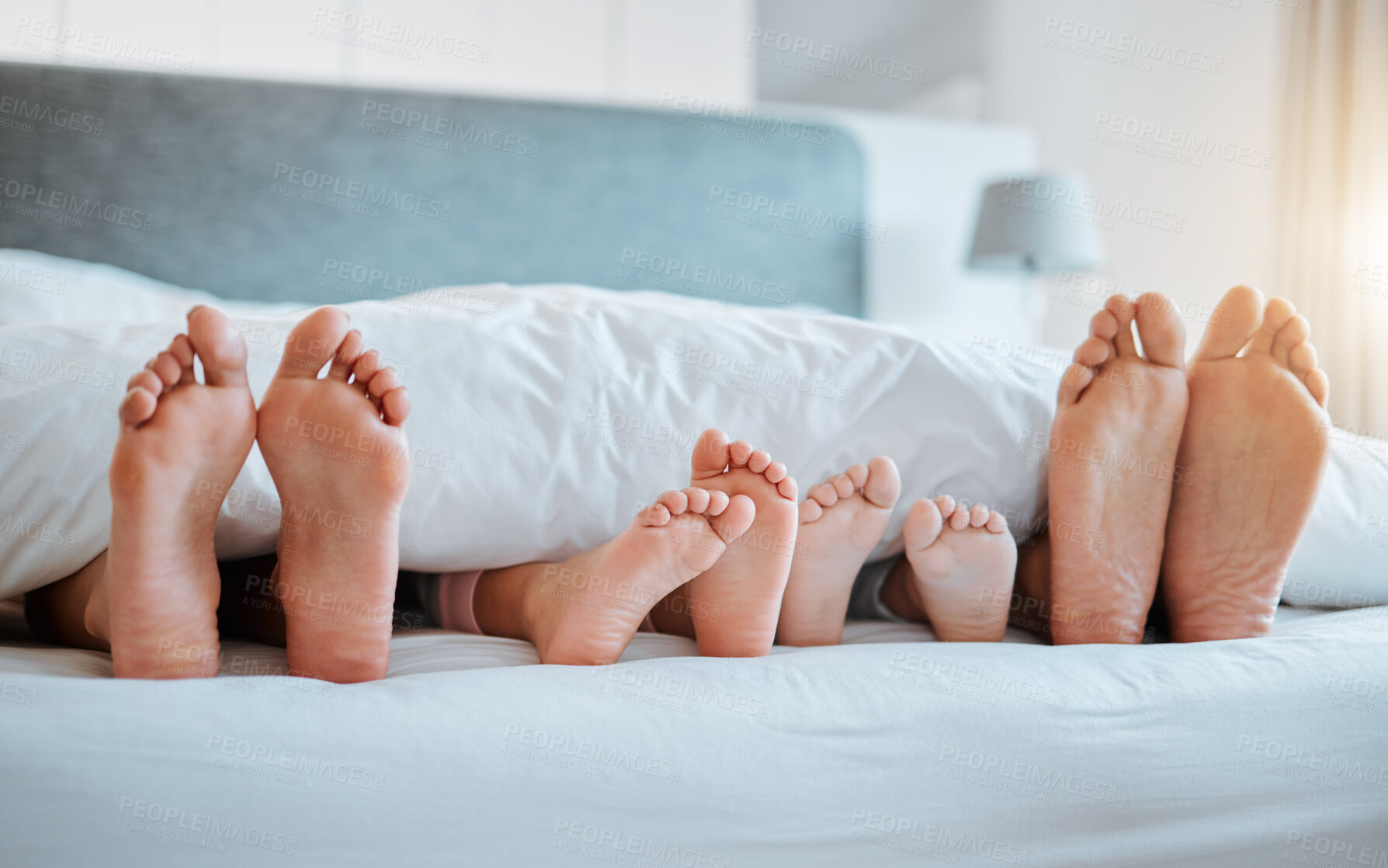 Buy stock photo Bed, feet and family together in the morning, sleeping or rest in bedroom on holiday, weekend or vacation. Mom, dad and children resting, dreaming or calm relaxing in home, house or hotel with kids