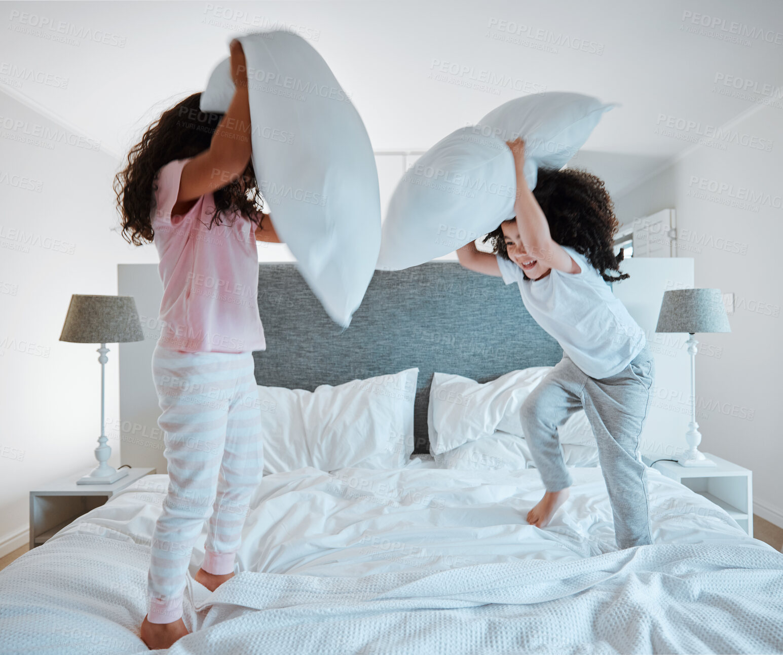 Buy stock photo Happy siblings, pillow fight and playing on bed in morning together for fun bonding at home. Little girls, children or kids enjoying playful game, entertainment or fighting with pillows in bedroom