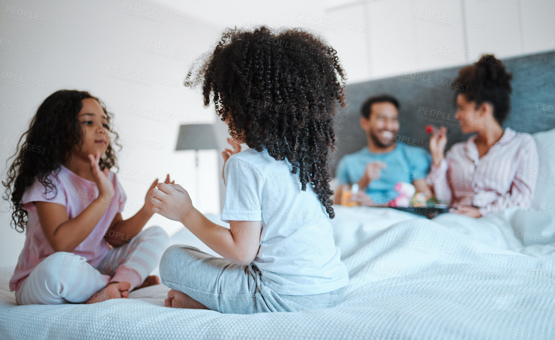 Buy stock photo Happy, breakfast and relax with family in bedroom for morning, love and care. Happiness, support and free time with parents and children in bed at home for wake up, bonding and peace together