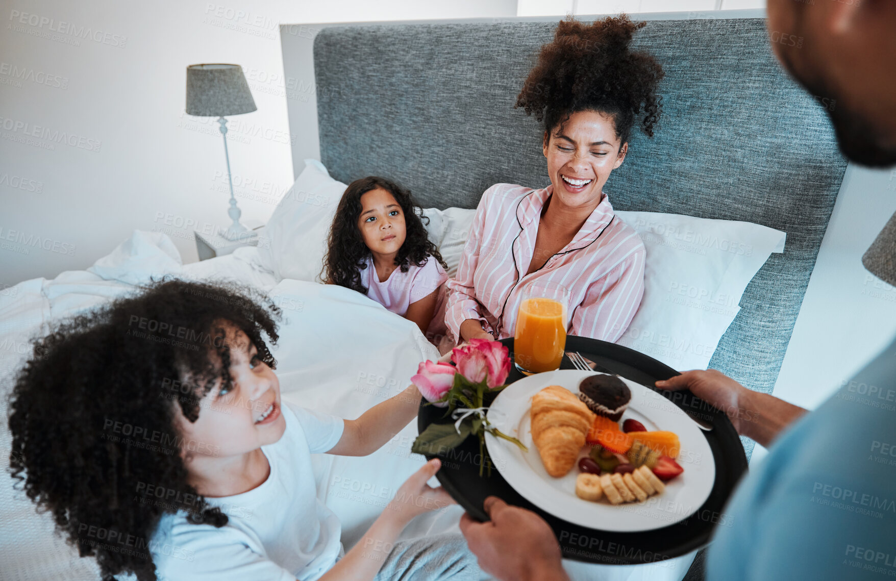 Buy stock photo Happy family, mothers day and morning breakfast in bed for celebration, love and care together at home. Father and children giving mom food, meal or gift for start, holiday or weekend in the bedroom