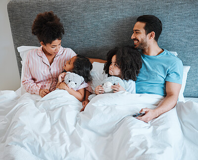 Buy stock photo Bonding, discussion and children in the bed with their parents talking and relaxing together in the room. Happy, smile and girl kids speaking for conversation with their mother and father in bedroom.