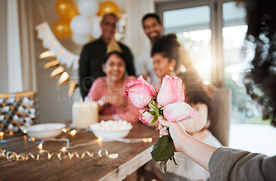 Buy stock photo Roses, family and hand with a gift for a celebration at a birthday, mothers day or party in a house. Giving present, love and a child with flowers for women or grandmother to celebrate mothers day