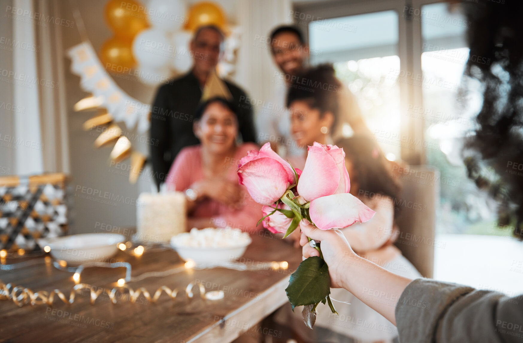 Buy stock photo Roses, family and hand with a gift for a celebration at a birthday, mothers day or party in a house. Giving present, love and a child with flowers for women or grandmother to celebrate mothers day