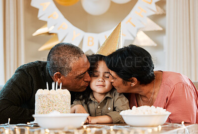 Buy stock photo Birthday, cake and grandparents kiss child in living room for event, party celebration and social gathering. Happy, surprise and grandma, grandpa and kid with dessert, snacks and presents at home