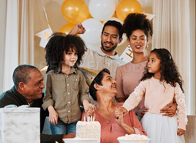 Buy stock photo Birthday, party and family with cake for grandmother in living room for event, celebration and social gathering. Happy, surprise and grandparents, parents and kids with dessert, snacks and presents