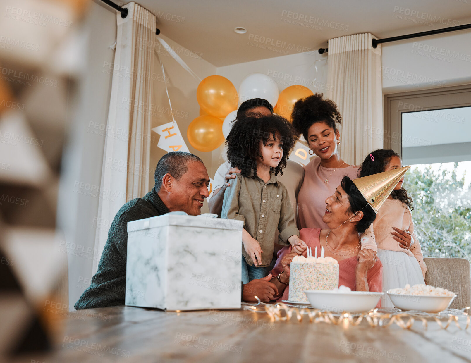 Buy stock photo Grandparents, parents and children with cake at birthday for event, celebration and social gathering. Happy family, surprise and kids with mom and dad for dessert, snacks and gifts in living room