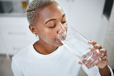 Buy stock photo Health, glass and woman drinking water for hydration, wellness and liquid nutrition at her home. Thirsty, energy and African female person enjoying cold healthy drink in the kitchen of her apartment.