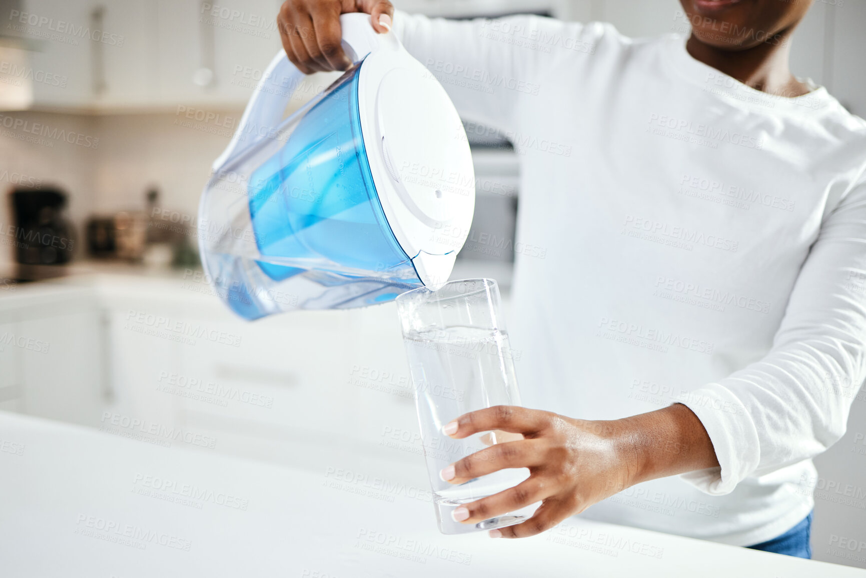 Buy stock photo Person, jug and glass of filter water in kitchen for fresh drink, liquid and hydration. Closeup, thirsty woman or pouring pure aqua beverage in container for nutrition, drinking or filtration at home