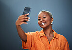 Selfie, smile and black woman in studio for photography, video call or photo on grey background. Smartphone, happy and lady social media influencer with profile picture, live streaming or blog update