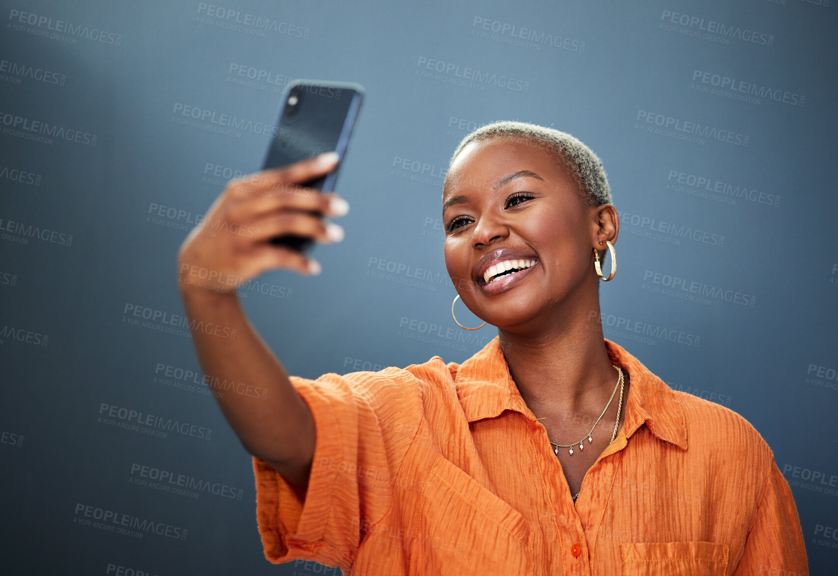 Buy stock photo Selfie, smile and black woman in studio for photography, video call or photo on grey background. Smartphone, happy and lady social media influencer with profile picture, live streaming or blog update