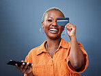 Portrait, phone and credit card with a black woman online shopping in studio on a gray background. Mobile, ecommerce and funny humor with a young female shopper looking excited for a deal or sale