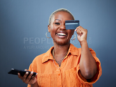 Buy stock photo Portrait, phone and credit card with a black woman online shopping in studio on a gray background. Mobile, ecommerce and funny humor with a young female shopper looking excited for a deal or sale