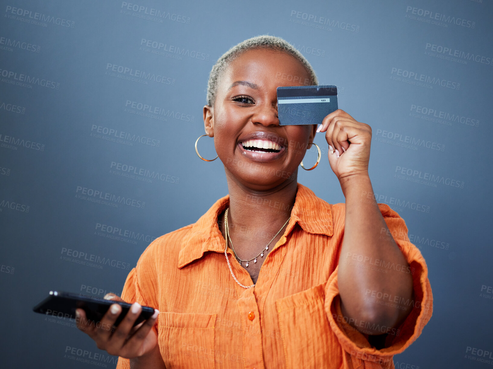 Buy stock photo Portrait, phone and credit card with a black woman online shopping in studio on a gray background. Mobile, ecommerce and funny humor with a young female shopper looking excited for a deal or sale