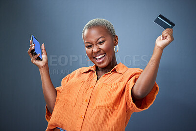 Buy stock photo Winner, phone and credit card with a black woman online shopping in studio on a gray background. Mobile, ecommerce and wow with a happy young female shopper in celebration of deal or sale success