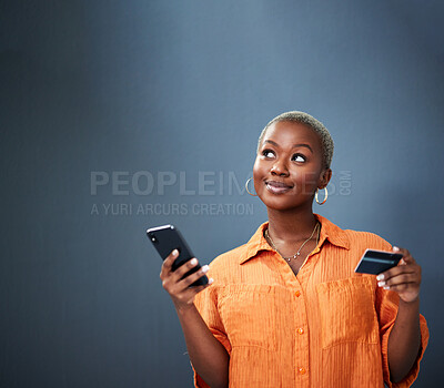 Buy stock photo Thinking, ecommerce and credit card with a black woman using her phone in studio on a gray background. Mobile, online shopping and finance payment with a female shopper searching for a deal or sale