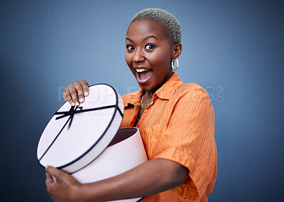 Buy stock photo African woman, open present or box in studio portrait with excited smile, surprise and blue background. Girl, happy and wow with package, gift and fashion for celebration, winner and birthday party