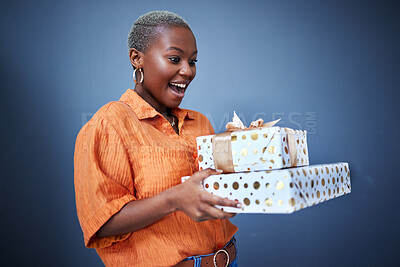 Buy stock photo Black woman, gift package and surprise in studio with excited smile, giveaway and blue background. African girl, happy and wow with box, present and fashion for celebration, winner and birthday party