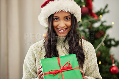 Buy stock photo Christmas, portrait or happy woman with a gift box or present on a holiday celebration at home. Face, smile or excited Indian girl with special product or giveaway prize package in a house in winter