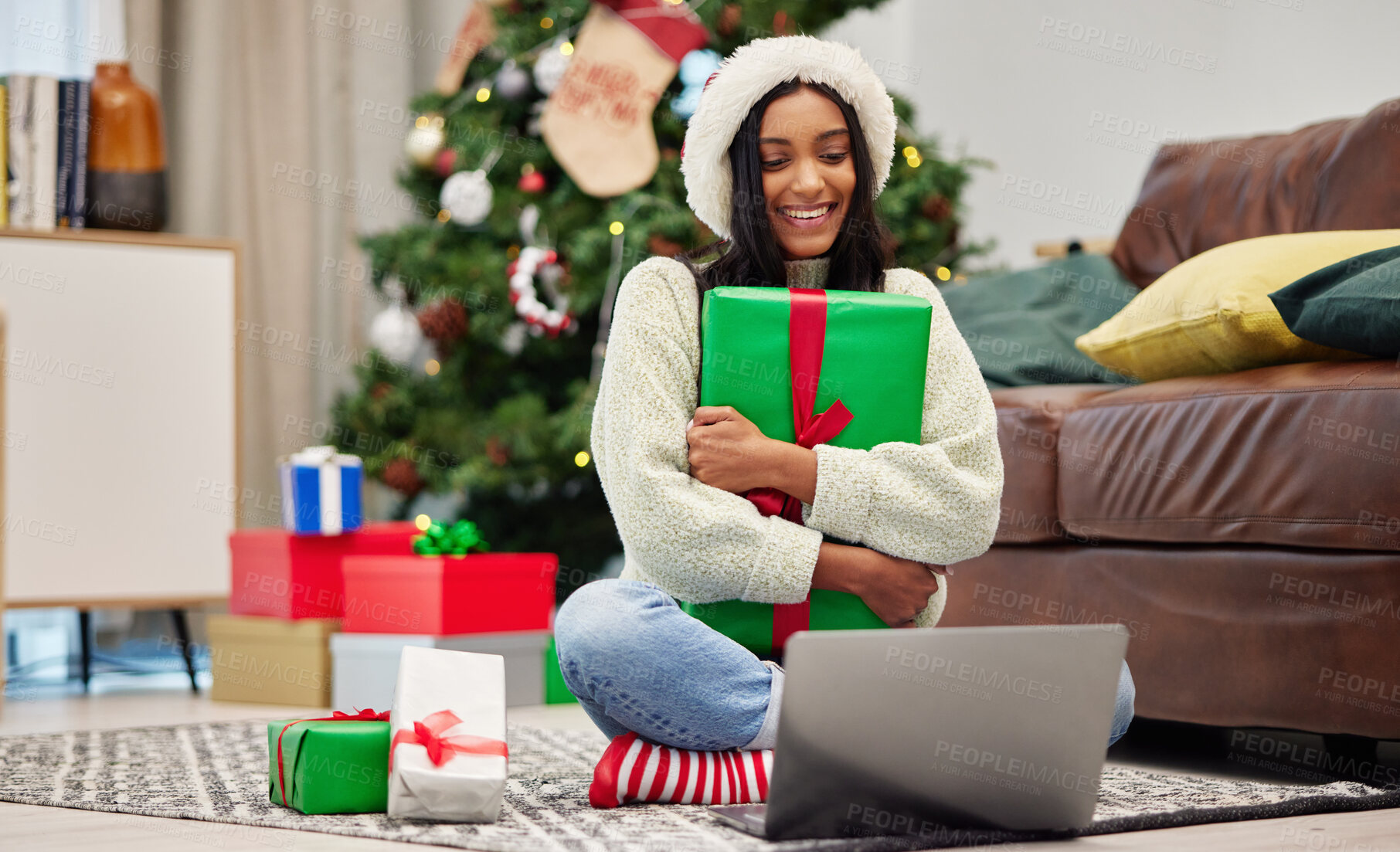 Buy stock photo Woman, Christmas present and laptop, video call and celebrate holiday, happiness and communication. Virtual conversation, contact on pc and female person at home with gift giving, package and smile