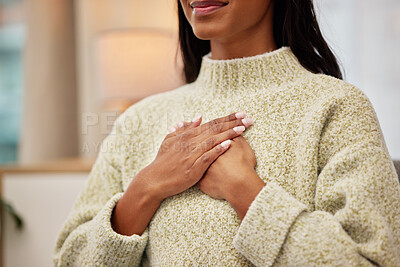 Buy stock photo Closeup of a woman holding her chest while breathing for calm, peace and zen mindset for meditation. Breathe, relax and zoom of a female person hands on her heart for grateful gesture in living room.