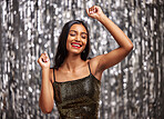 Dance, celebration and happy Indian woman in studio for party, birthday or disco against a silver background. Smile, freedom and female person dancing at an event or festival with good mood or vibes