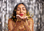 Woman, blow gold glitter and celebration with party and sparkle, bokeh with New Years and festive. Happiness, excited and female person, confetti and anniversary with aesthetic and special event 