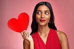 Woman, paper heart and thinking in studio with makeup, beauty and romantic sign by red background. Young girl, ideas and cardboard emoji with love for cosmetics, valentines day date and aesthetic