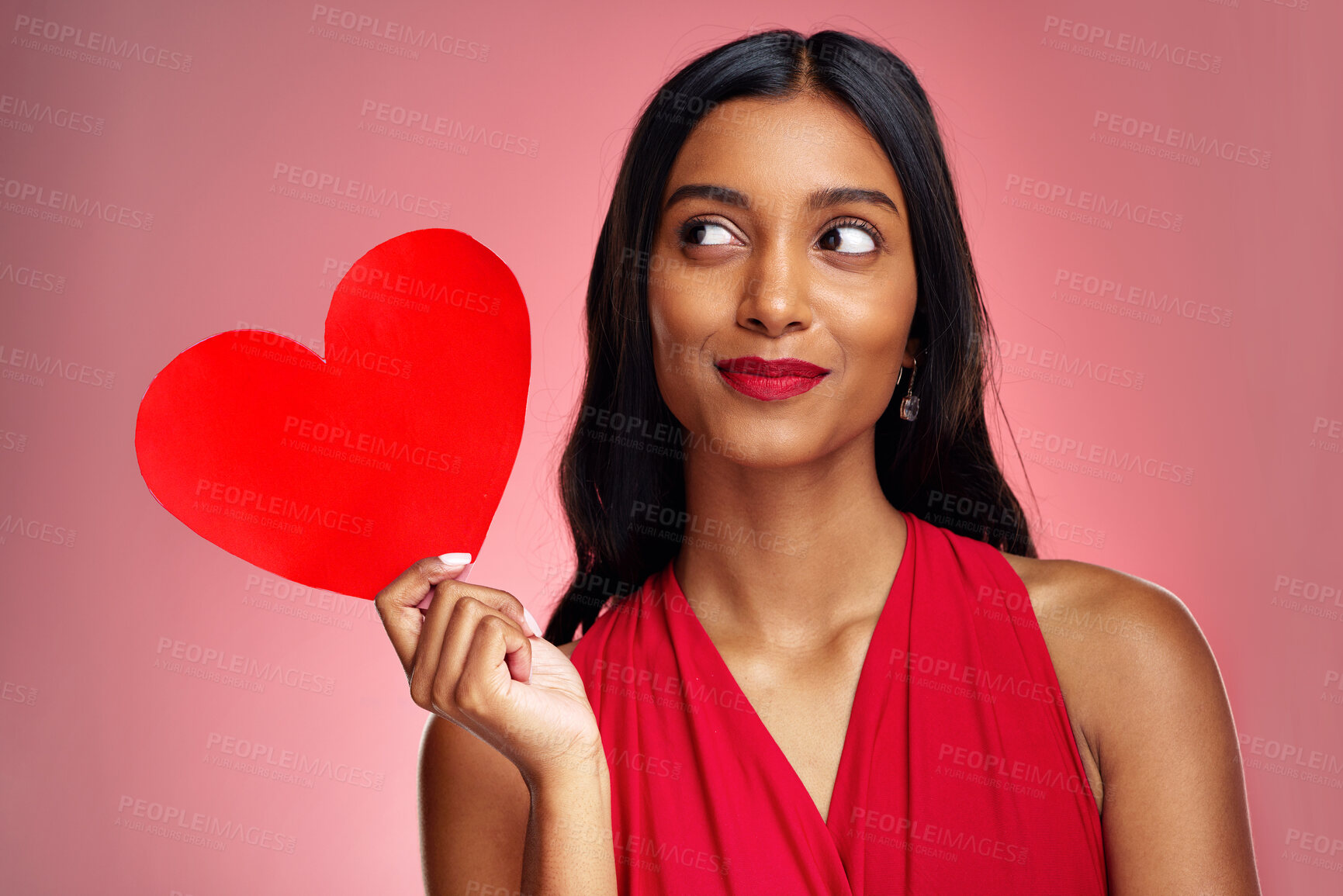 Buy stock photo Woman, paper heart and thinking in studio with makeup, beauty and romantic sign by red background. Young girl, ideas and cardboard emoji with love for cosmetics, valentines day date and aesthetic