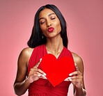 Woman, paper heart and kiss in studio with lips, makeup and beauty with romantic sign by red background. Girl, fashion model and cardboard emoji with love for cosmetic, valentines day date or pout