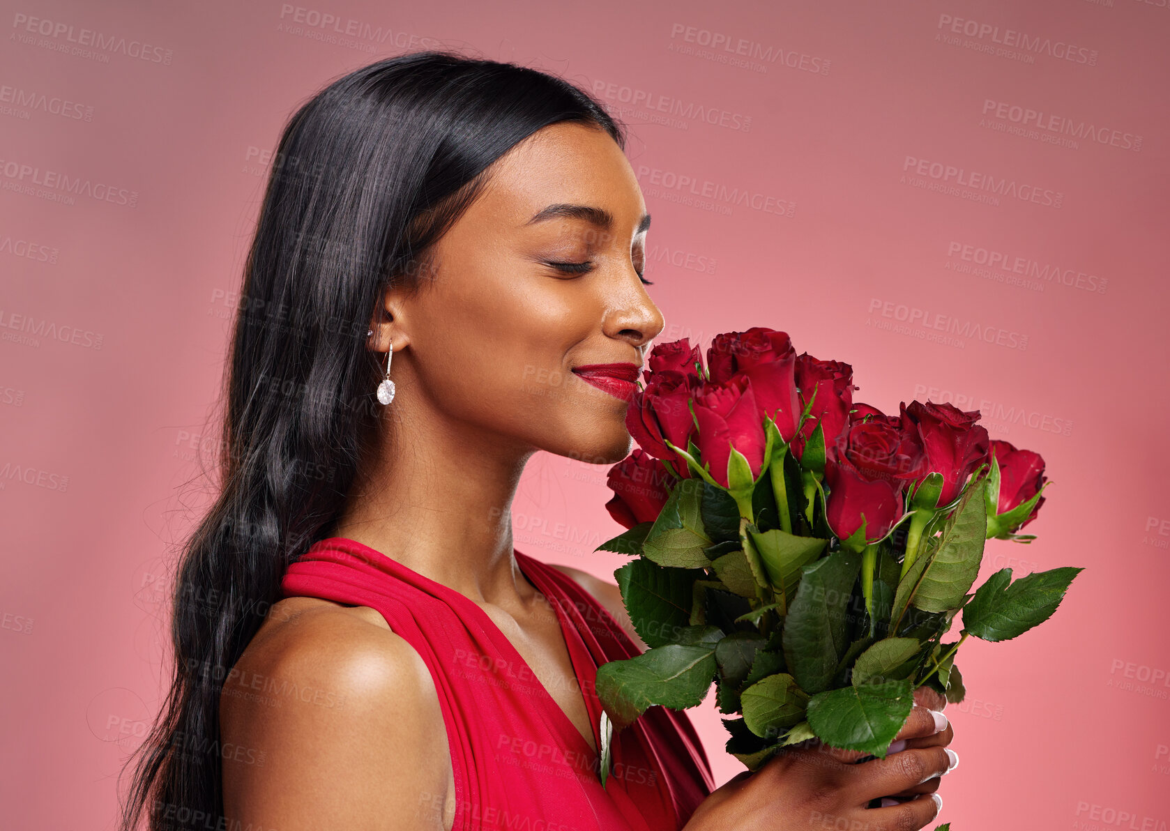 Buy stock photo Face, beauty and a woman smelling a roses on a studio background for valentines day. Makeup, model and happy young Indian girl profile with a flower bouquet for romance or love on pink backdrop