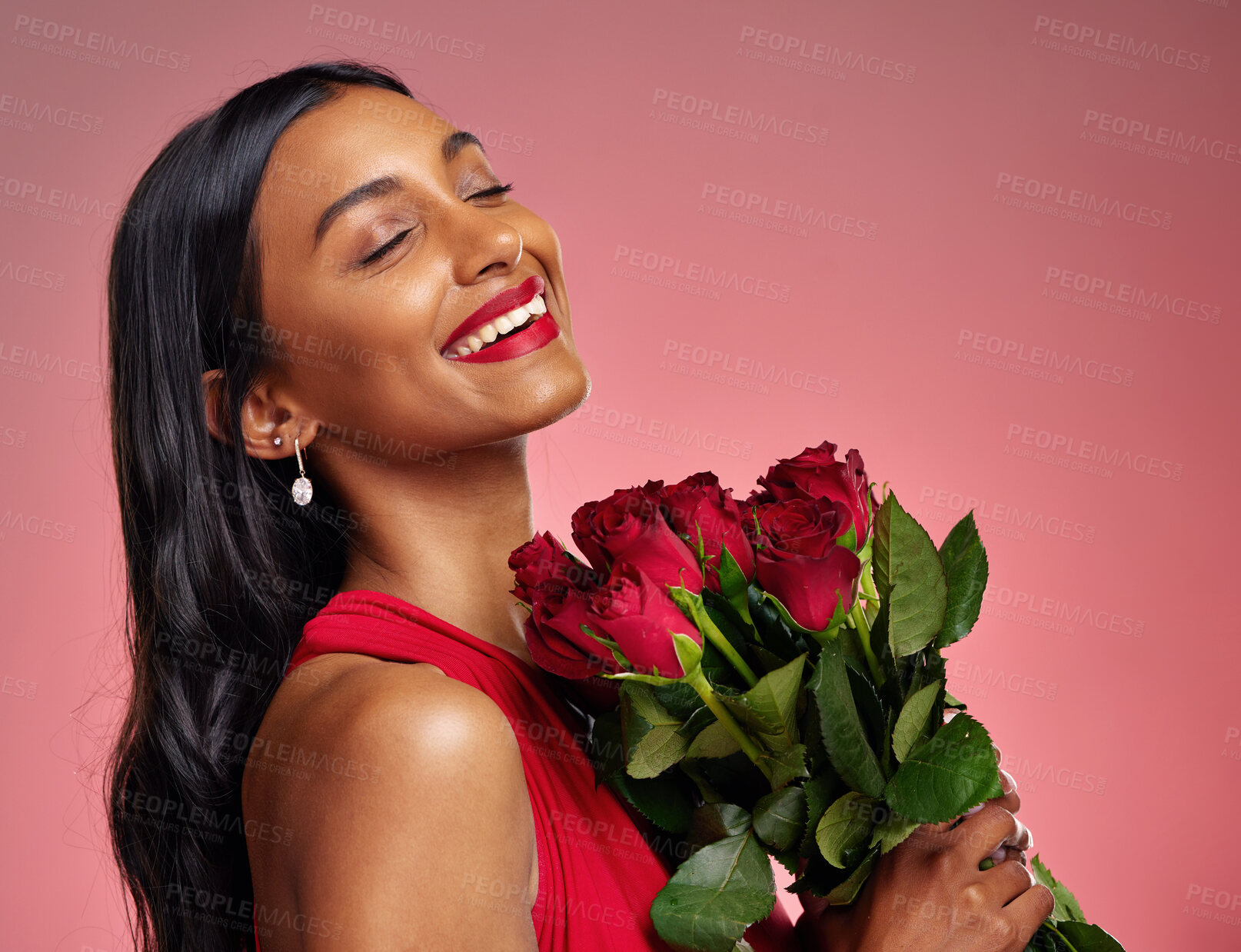 Buy stock photo Face, beauty and smile of a woman with a roses on a studio background for valentines day. Makeup, model and happy young Indian girl with a flower bouquet for romance or love on a pink backdrop