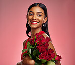 Happy, flowers and portrait of an Indian woman on a studio background for valentines day. Smile, beautiful and a young model or girl with a floral bouquet on a backdrop for luxury present of roses