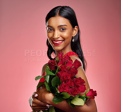 Buy stock photo Pageant, flowers and portrait of an Indian woman on a studio background for valentines day. Smile, happy and a young model or girl with a floral bouquet on a red backdrop for luxury present of roses