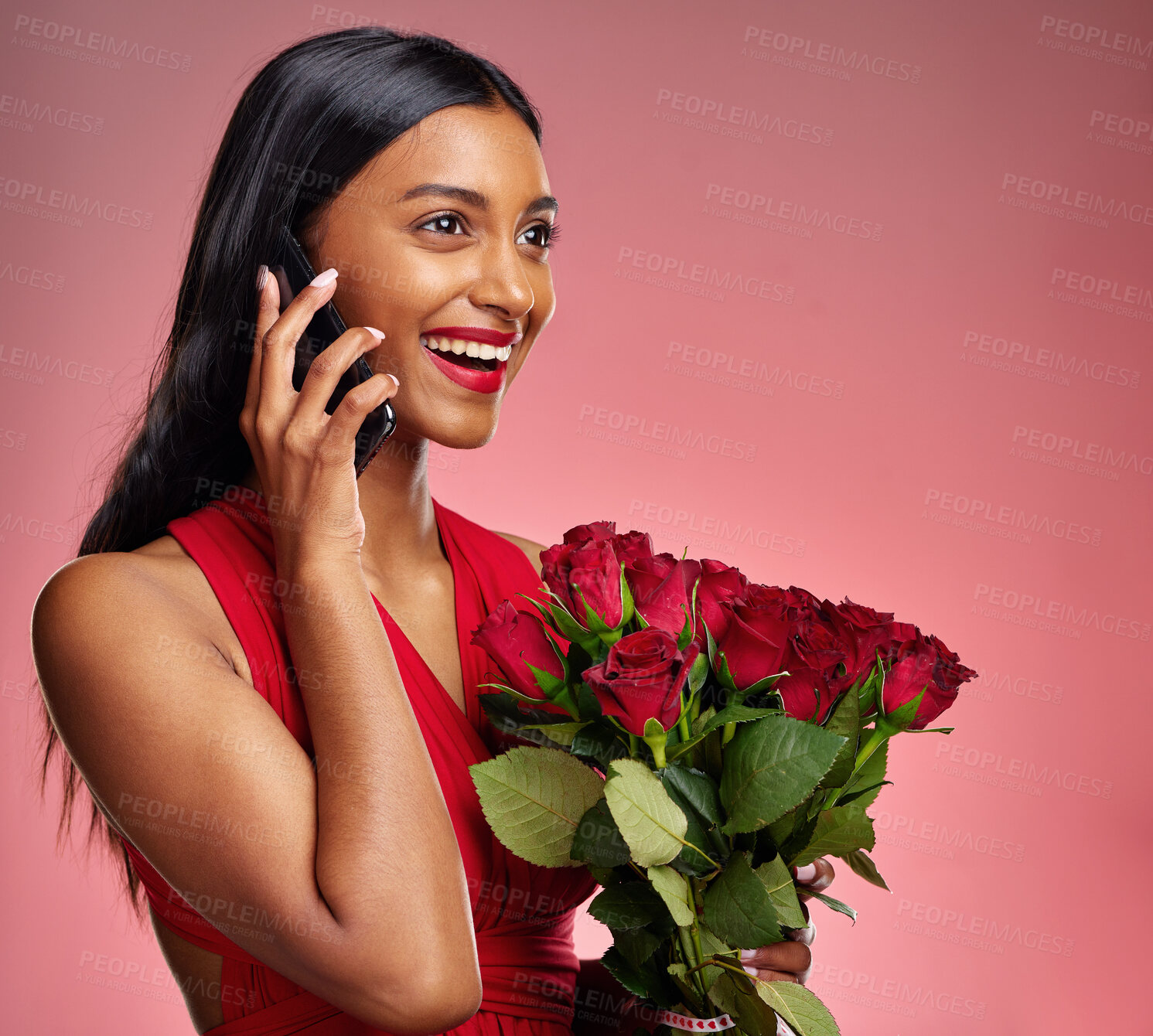 Buy stock photo Phone call, laugh and a happy woman with roses on a studio background for valentines day. Smile, model and face of a young Indian girl with a flower bouquet and smartphone for romance, chat and love