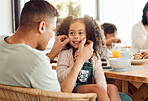 Father, child and smile of a girl at home for bonding, love and care or quality time. Face of a kid or daughter and a happy man in a house for happiness, relax and playing with cheeks at breakfast