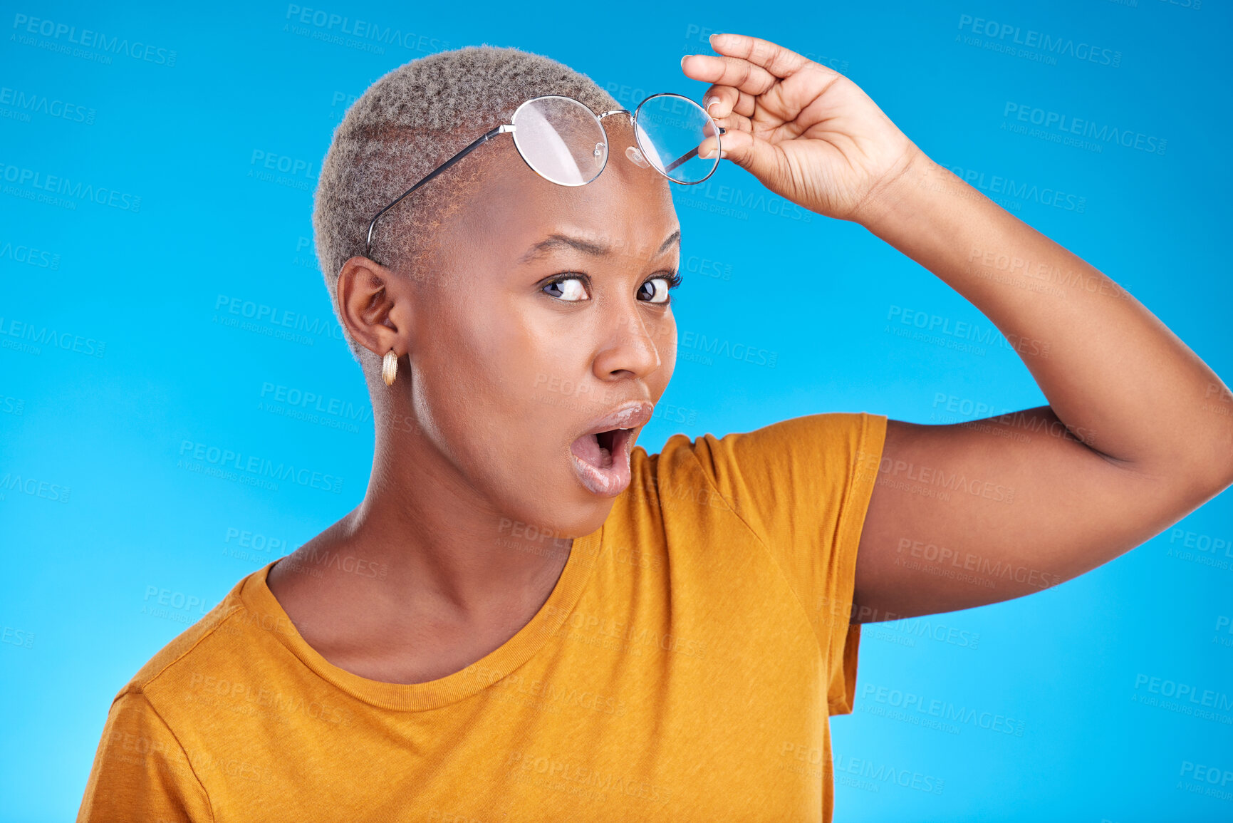 Buy stock photo Portrait, news and black woman shocked, gossip and announcement against a blue studio background. Face, female person and model with glasses, surprise and deal with omg facial and wow with expression