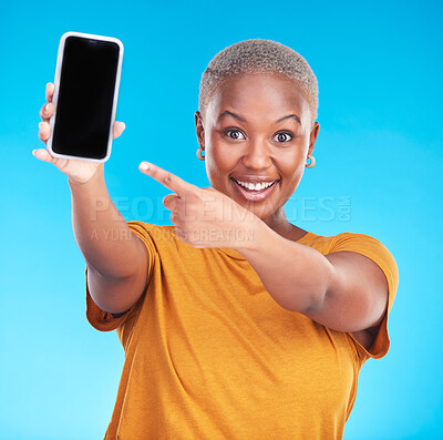 Buy stock photo Portrait, phone screen and happy black woman point at studio advertising space, online app promo or web news. Smile, smartphone UI mockup and African person gesture at mobile deal on blue background