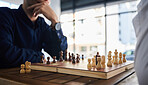 Board game, chess and men playing at a table in office while thinking of strategy or plan. Male friends together to play, relax and bond with wooden icon for problem solving, competition or checkmate