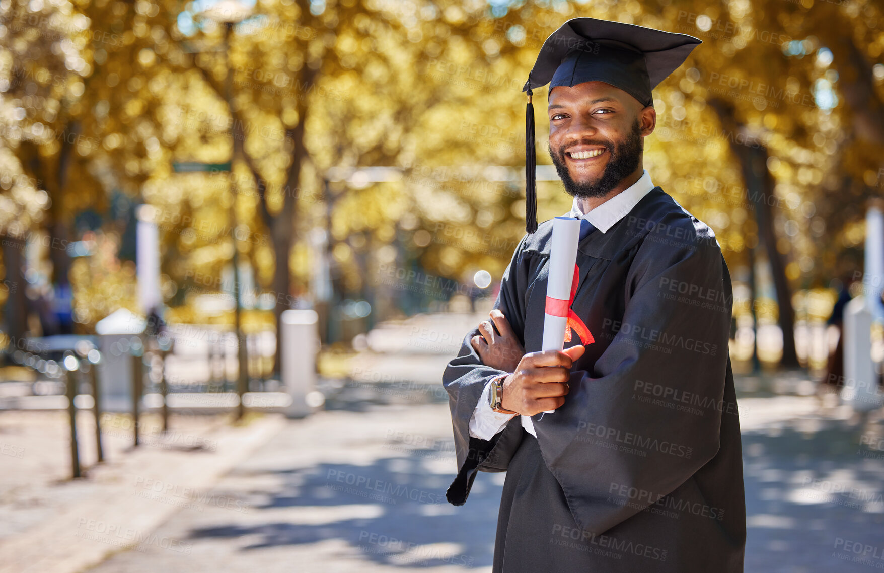 Buy stock photo Graduation portrait, diploma and man or student on university, education or college campus and scholarship success. African person or happy graduate arms crossed with certificate or award in park