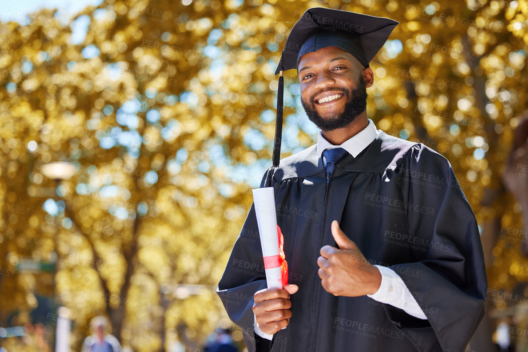 Buy stock photo Graduation portrait, thumbs up and man or student on university, education or college campus in diploma success. African person or graduate like, yes and excellence sign, certificate or award in park