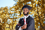 Graduation cap, portrait and man or student on university, education or college campus and scholarship success. African person or happy graduate arms crossed with diploma or certificate award in park