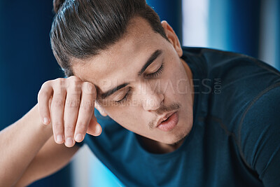Buy stock photo Exercise, sweat and a tired sports man breathing in the gym after an intense or physical workout for health. Fitness, fatigue and a young male athlete or runner finished with his cardio training