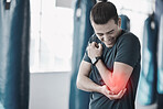 Hand, elbow pain and injury with the arm of a man in red highlight during a fitness workout. Healthcare, medical and emergency with a young male athlete holding a joint after an accident in the gym