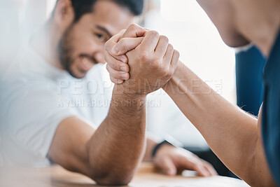 Buy stock photo Strong, hands and closeup of men arm wrestling on a table while being playful for a challenge. Rivalry, game and zoom of male people doing a strength muscle battle for fun, bonding and friendship.