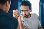 Arm wrestling, men and strength challenge with strong muscle at a gym for battle. Hand wrestle, power and male friends or athletes together for sport, competition or contest with focus and commitment