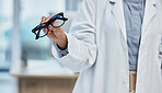 Optometry, health and closeup of a optometrist with glasses at optical store or clinic. Eye care, wellness and zoom of optician or medical worker with prescription spectacles or eyewear frame at shop
