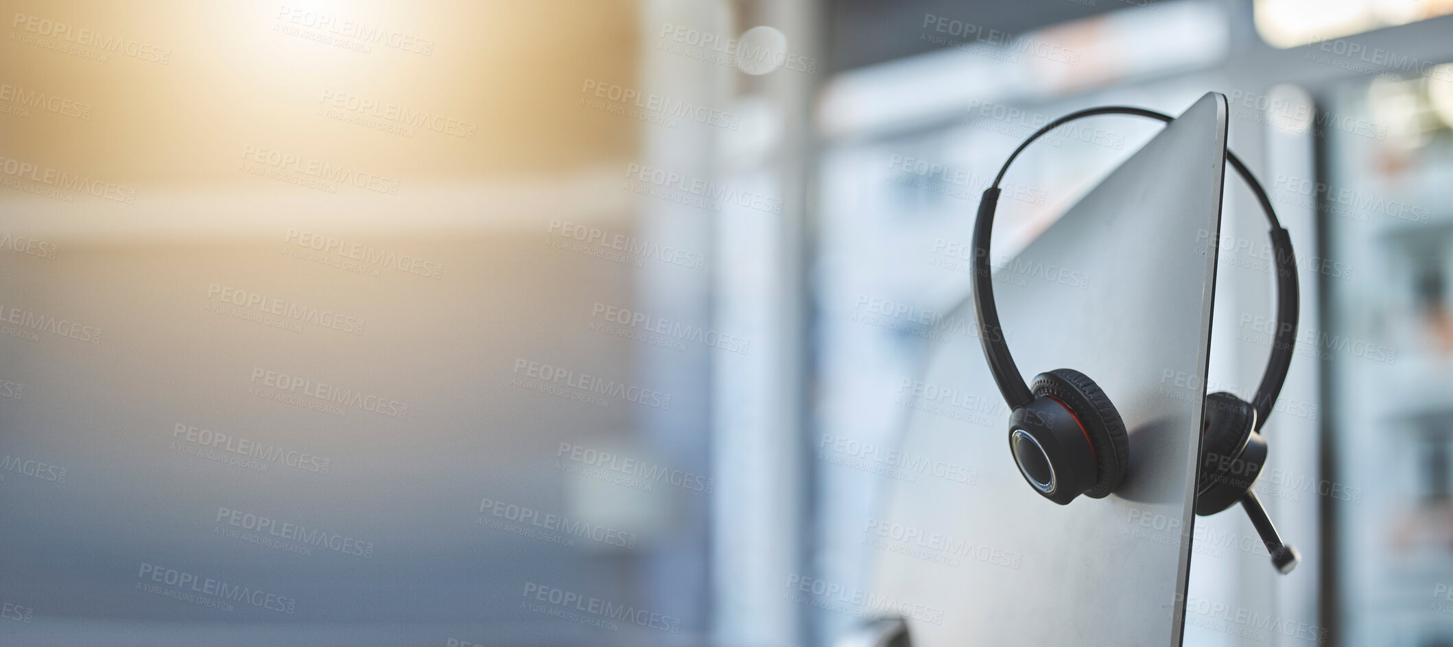Buy stock photo Call center, headset on a computer in an empty office with flare and mockup for communication or assistance. Customer care, support and equipment in a workplace after hours for help or service